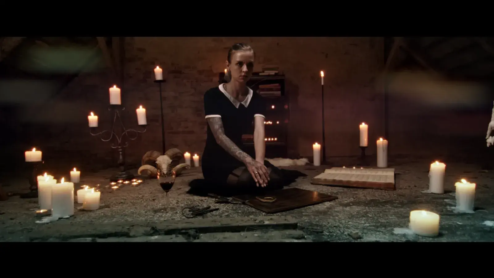 Screenshot with desaturated color tones, creating an eerie and unsettling atmosphere typical of horror movies.