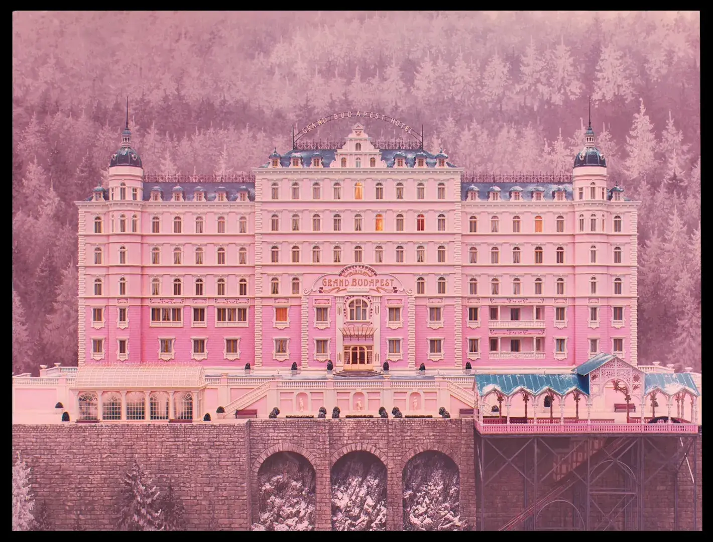Screenshot from The Grand Budapest Hotel. The image demonstrates intentionally unnatural, stylized color choices where certain hues are dramatically enhanced while others are subdued, creating a unique visual atmosphere that supports the film's storytelling rather than aiming for realism.